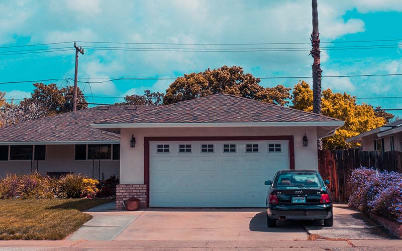 Car parked in front of stuck garage door