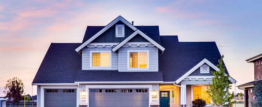 A blue home with two garage doors