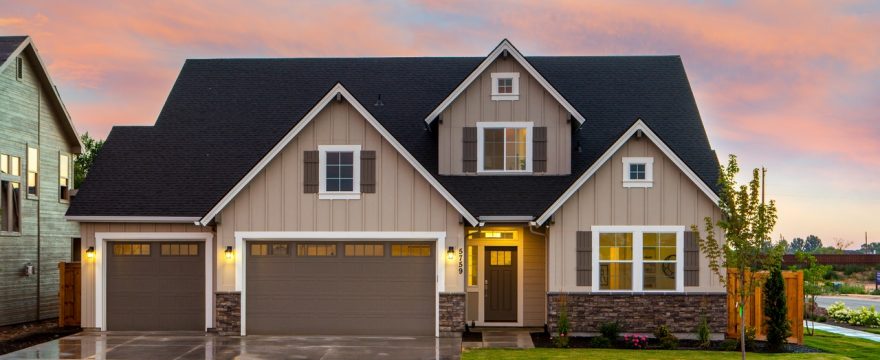 A tan house with a three-car garage