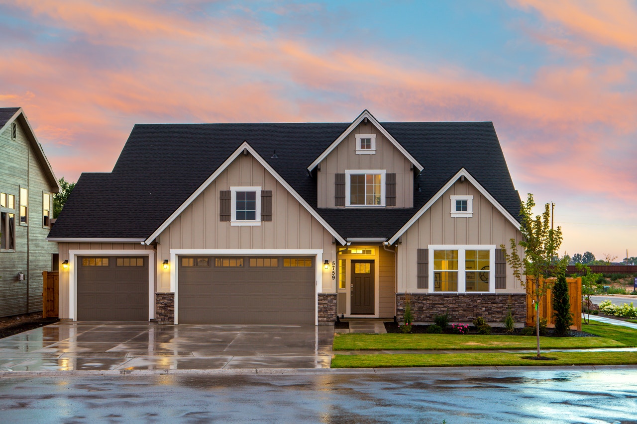 A tan house with a three-car garage